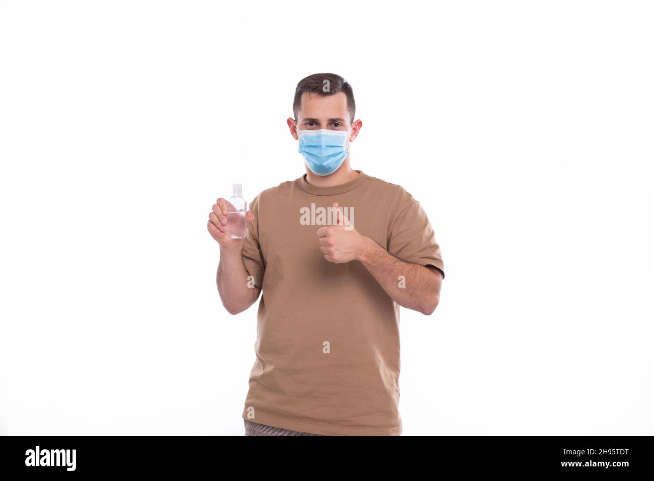 Man Holding Hands Sanitizer Wearing Medical Mask Isolated Stock Photo ...
