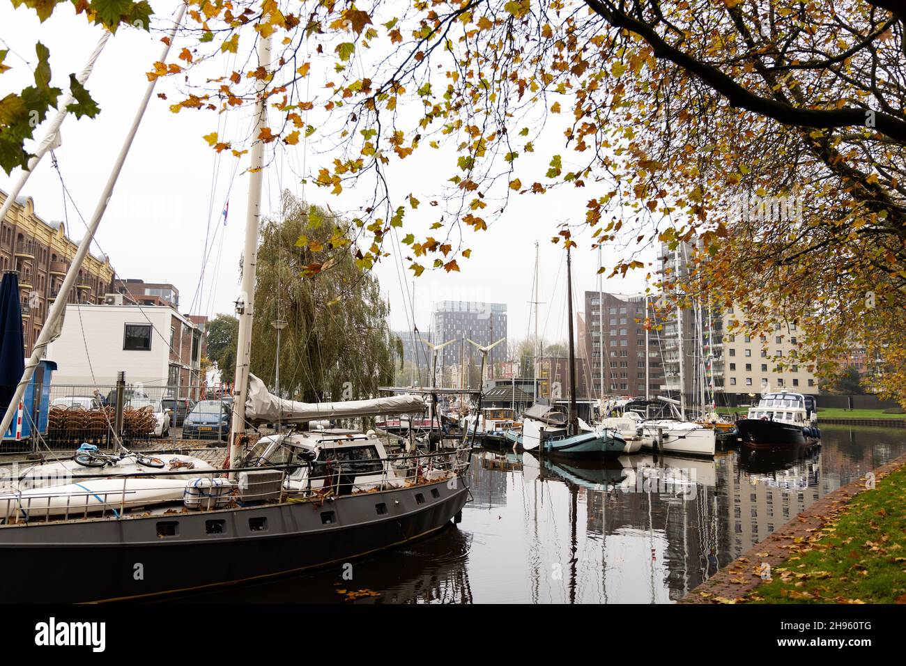 Boats in the Oosterhaven (East Harbor) on a fall day in Groningen, Netherlands. Stock Photo