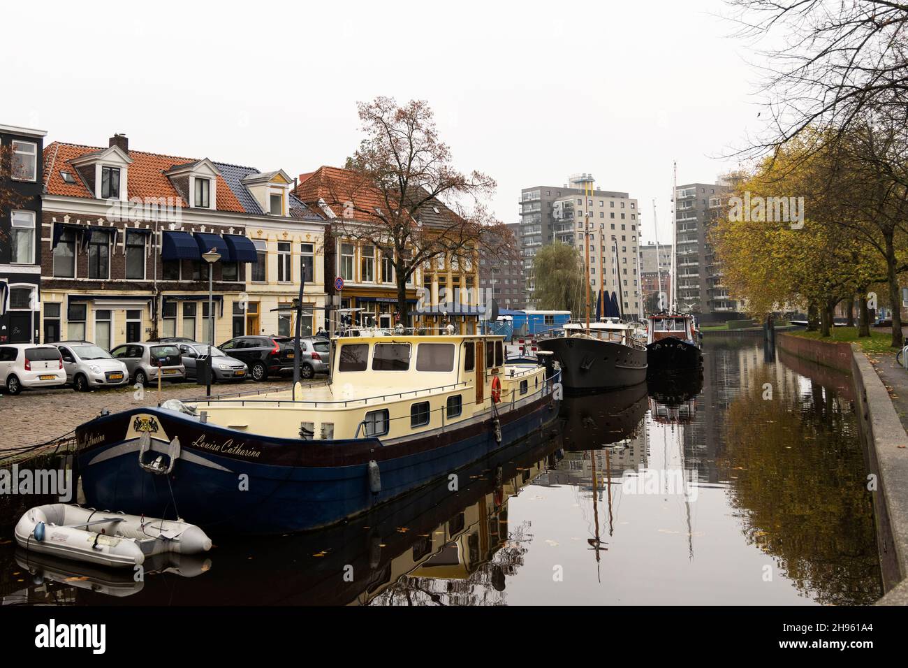 Looking across the canal toward shops and restaurants on Schuitendiep from Winschoterkade near the Oosterhaven in Groningen, Netherlands. Stock Photo