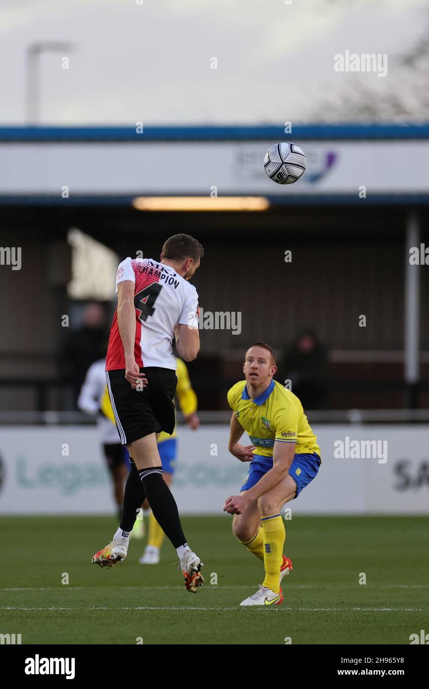 SOLIHULL, ENGLAND. DECEMBER 4TH 2021. Tom Champion of Woking FC heads the ball watched by Adam Rooney of Solihull Moors during the Vanarama National League match between Solihull Moors and Woking FC at the Armco Stadium, Solihull on Saturday 4th December 2021. (Credit: James Holyoak/Alamy Live News) Stock Photo