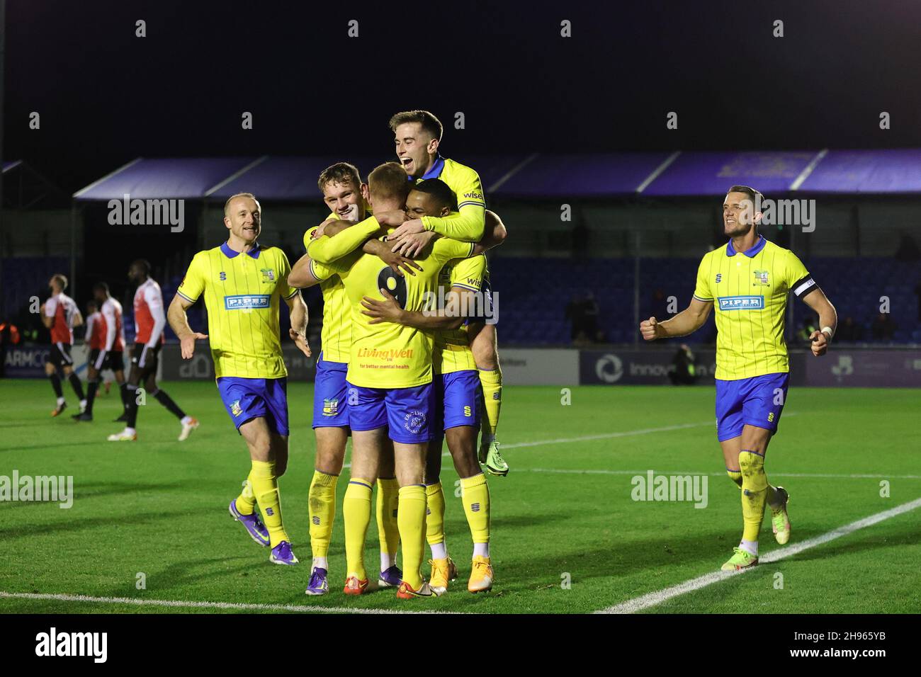 SOLIHULL, ENGLAND. DECEMBER 4TH 2021. Adam Rooney of Solihull Moors (9) celebrates with teammates after scoring his sides second goal during the Vanarama National League match between Solihull Moors and Woking FC at the Armco Stadium, Solihull on Saturday 4th December 2021. (Credit: James Holyoak/Alamy Live News) Stock Photo