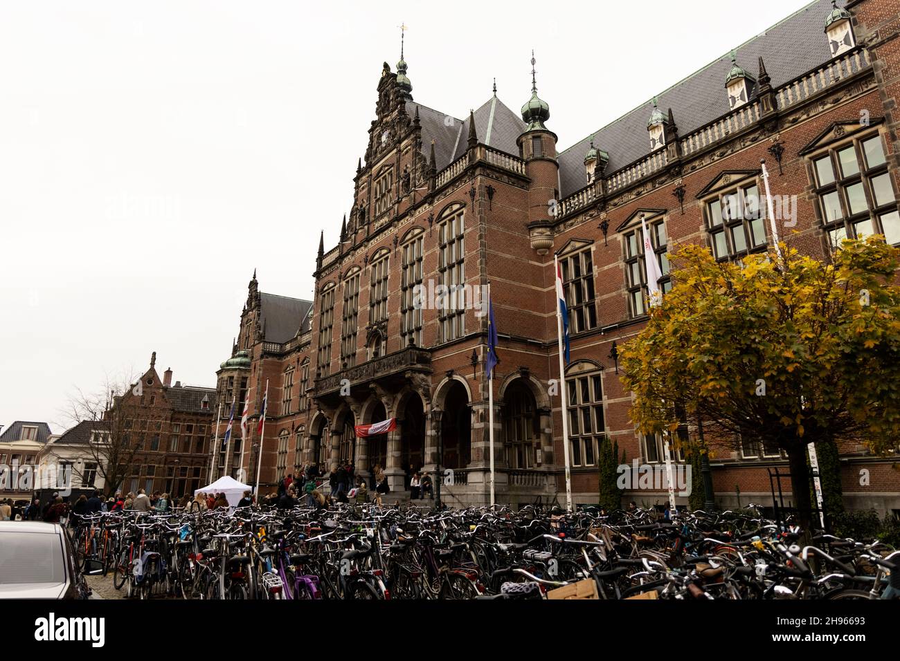 The Academy Building houses the administration of the University of Groningen in the Netherlands. Parking for student bikes spans the front. Stock Photo