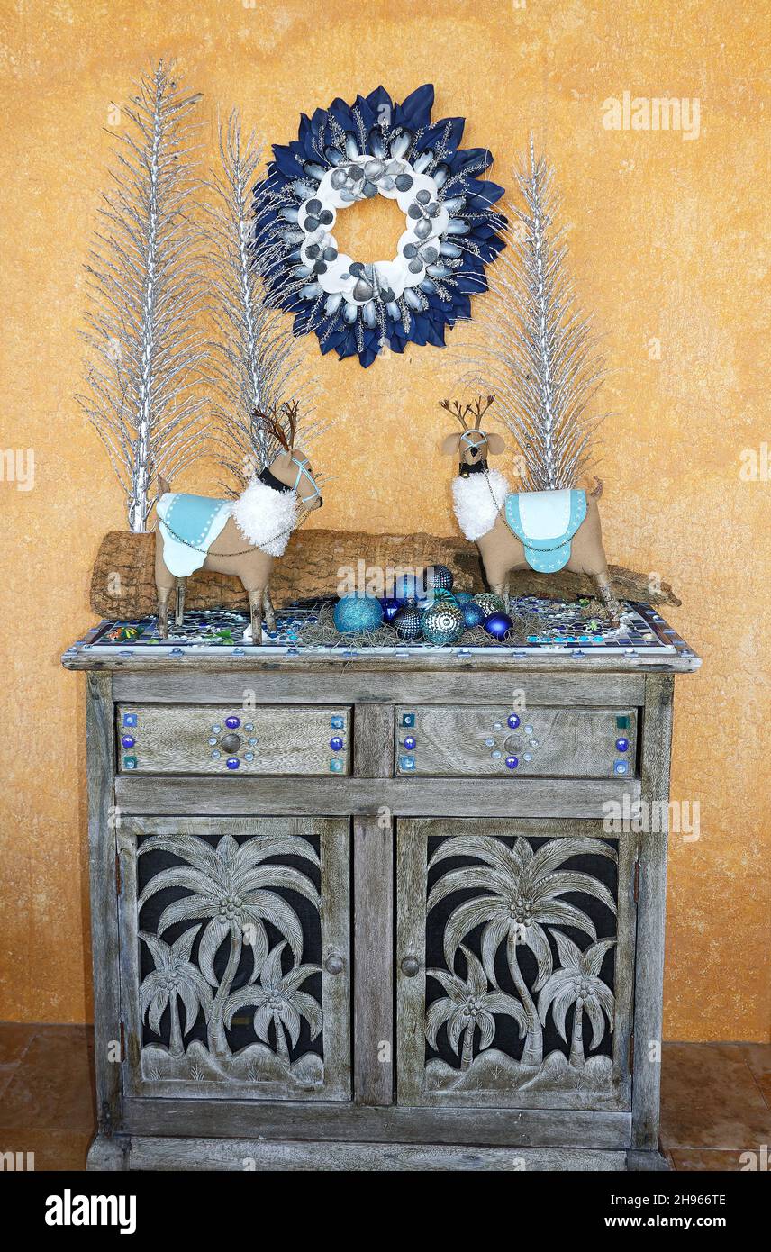 Christmas decoration, blue, white, silver, 2 deer figures, wreath in natural materials, ball ornaments, twigs, distressed grey chest, holiday, festive Stock Photo