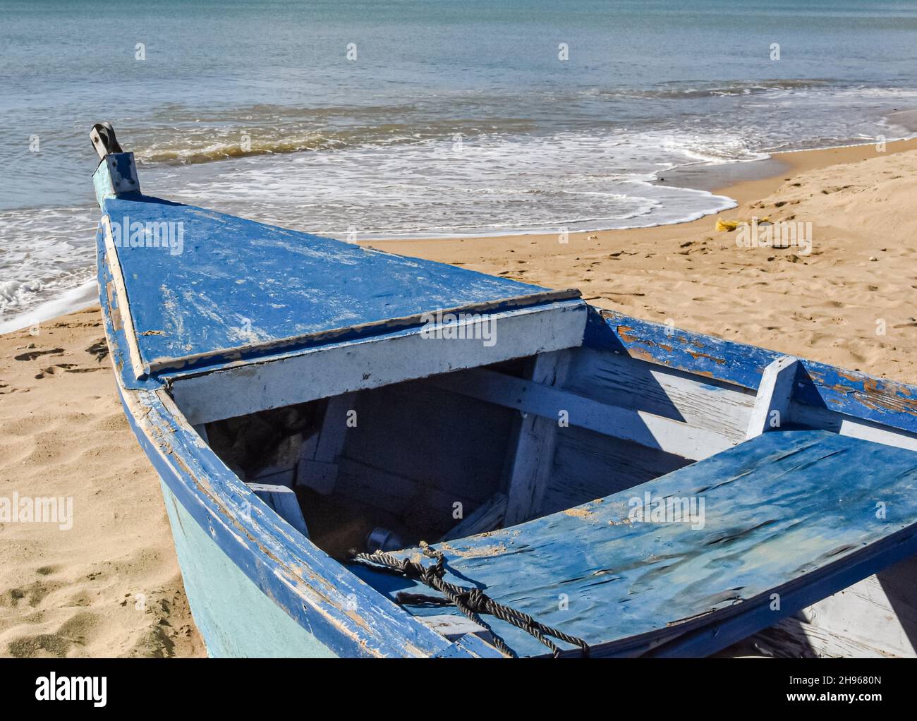 Close up of a traditional Puerto Rican fishing boat on a sand beach. Copy space. Stock Photo