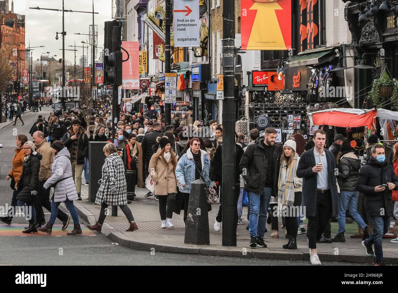 London, UK. 4th Dec, 2021. Camden High Street and Camden Market are busy, with visitors and shoppers crowding into shops, indoor and outdoor food outlets and along the stalls, with little visible mitigation to practice social distancing so far and indoor mask wearing apparently not strictly enfornced. Credit: Imageplotter/Alamy Live News Stock Photo