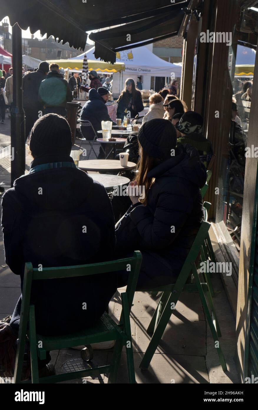 People eating and drinking at a cafe in Broadway market in Hackney,London,England,UK Stock Photo