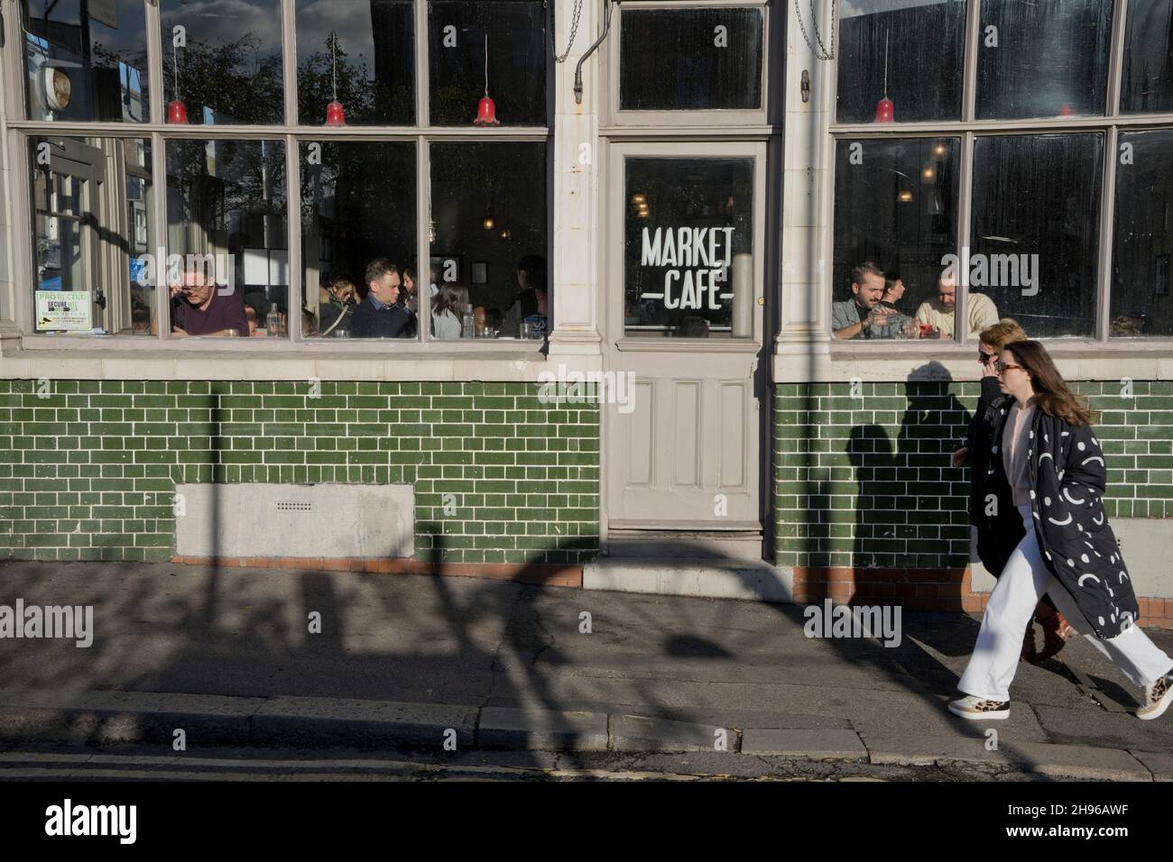 People eating and drinking at a cafe in Broadway market in Hackney,London,England,UK Stock Photo