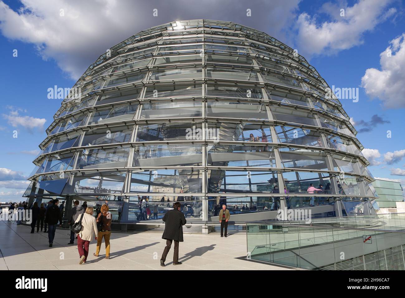 The Reichstag dome on the roof of the German Bundestag in Berlin Mitte from the outside. Modern architecture made of aluminum, glass and mirrors. Stock Photo