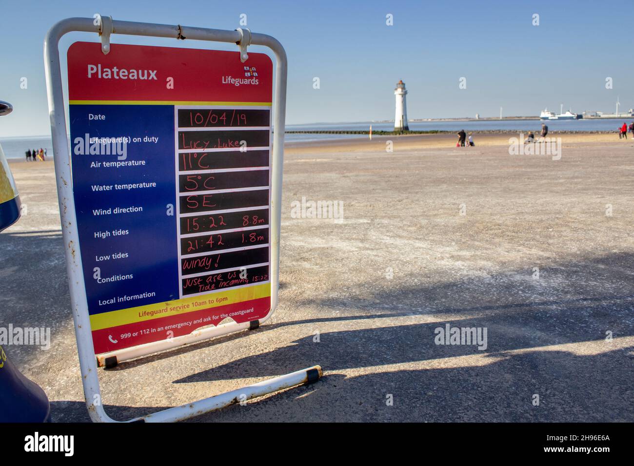 New Brighton, UK: Lifeguard information board, including tide times, next to the beach. Stock Photo