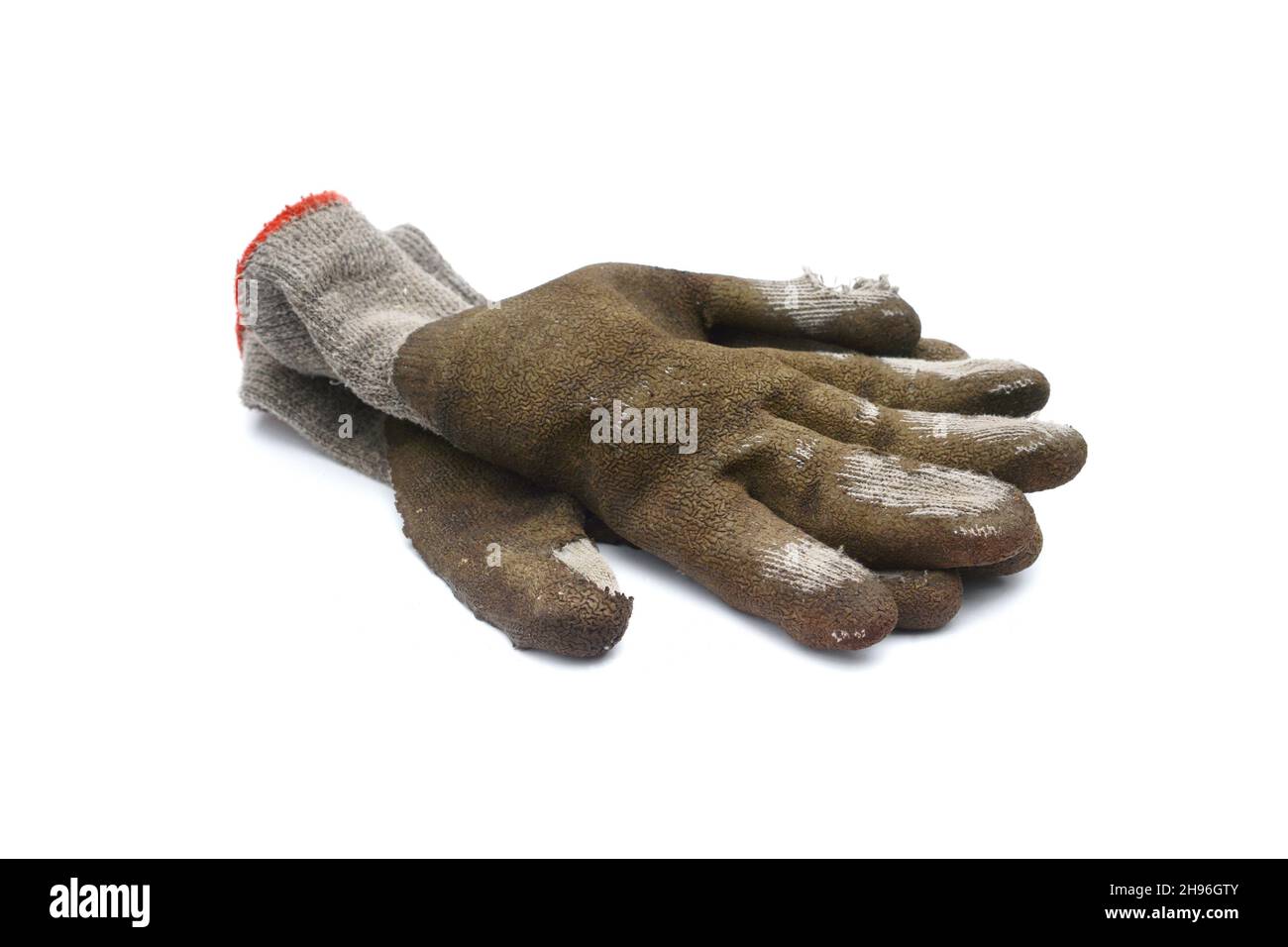 Used old dirty torn worker's gloves isolated on white background. Stock Photo
