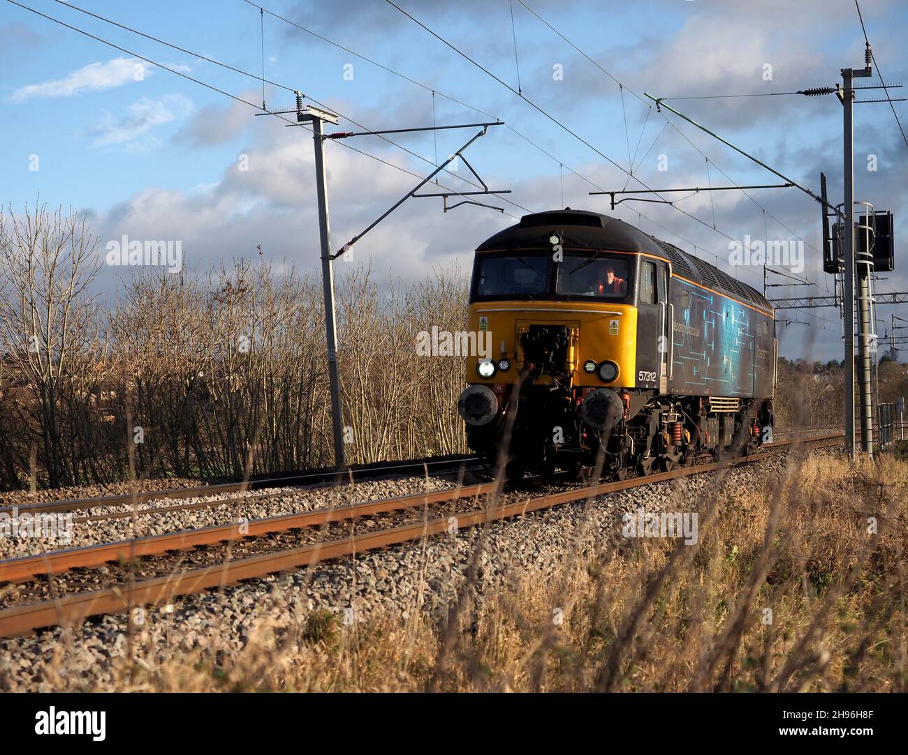 Class 57 diesel locomotive 57312 of Rail Operations Group heads north from Northampton on the West Coast Mainline Stock Photo