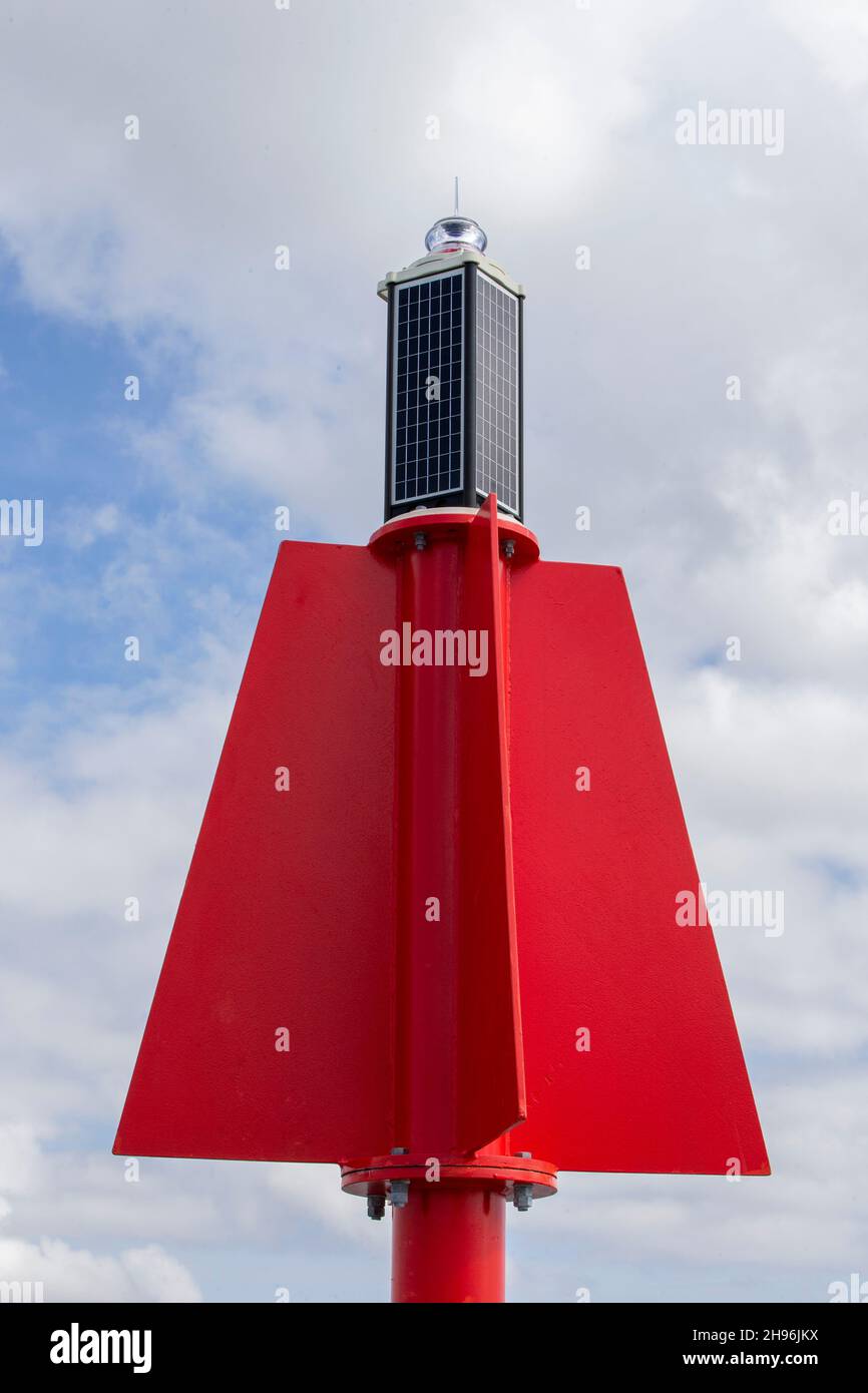 Red port marker signal buoy against blue sky Stock Photo