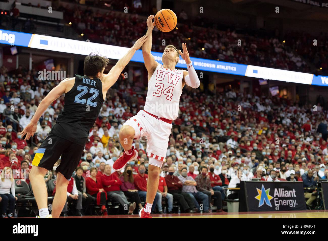 Madison, WI, USA. 4th Dec, 2021. Marquette Golden Eagles guard Tyler Kolek #22 fouls Wisconsin Badgers guard Brad Davison #34 during NCAA basketball game between the Marquette Golden Eagles and the Wisconsin Badgers at Kohl Center in Madison, WI. Kirsten Schmitt/CSM/Alamy Live News Stock Photo