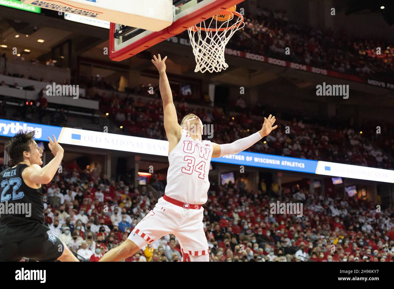 Madison, WI, USA. 4th Dec, 2021. Marquette Golden Eagles guard Tyler Kolek #22 and Wisconsin Badgers guard Brad Davison #34 wait to see if the basket is good after Kopek fouled Davison during NCAA basketball game between the Marquette Golden Eagles and the Wisconsin Badgers at Kohl Center in Madison, WI. Wisconsin defeated Marquette 89-76. Kirsten Schmitt/CSM/Alamy Live News Stock Photo