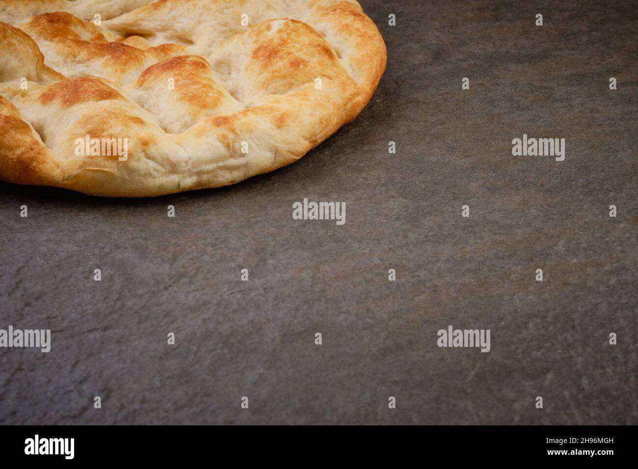 Pita bread on stone table surface Stock Photo
