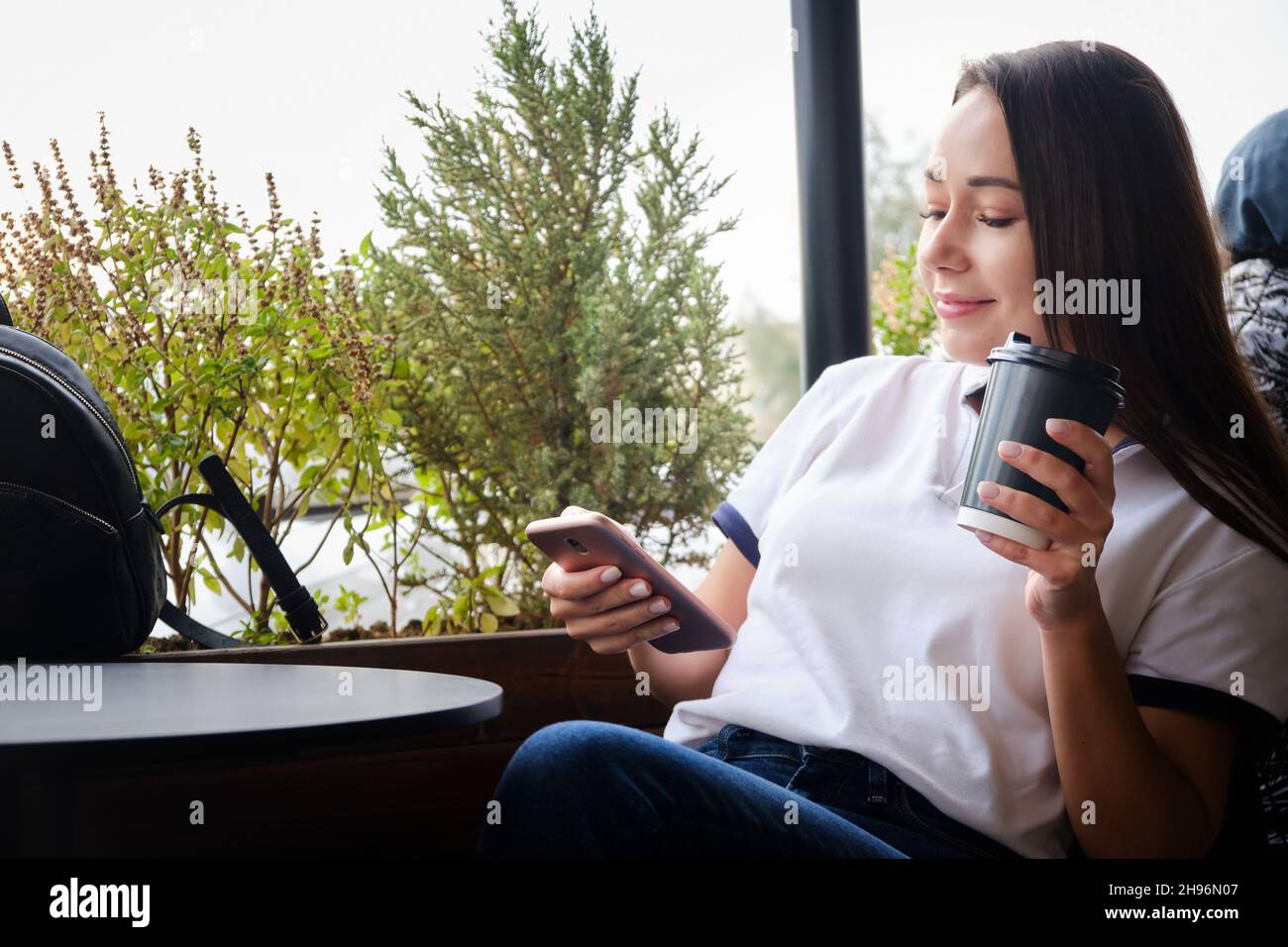 Woman texting in a cafe Stock Photo