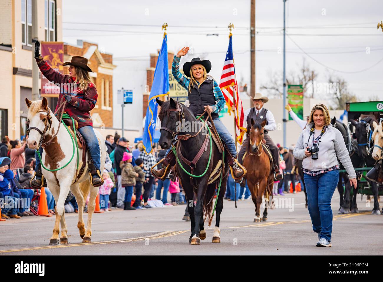 Oklahoma, DEC 4, 2021 Cowboy and cowgirl riding horse in Cowboy
