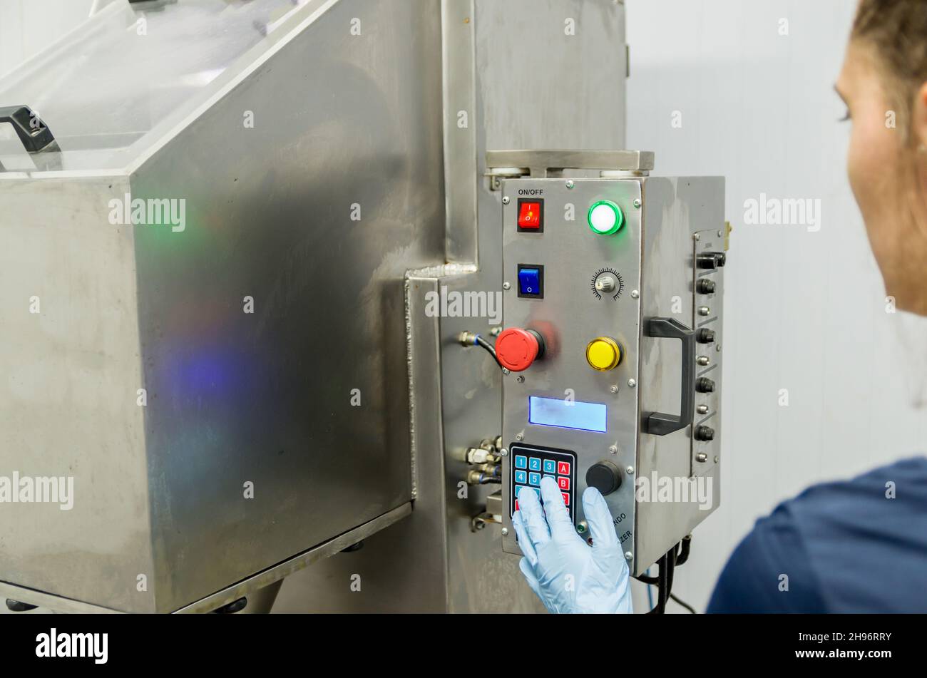 Woman working in industry, adjusting equipament Stock Photo