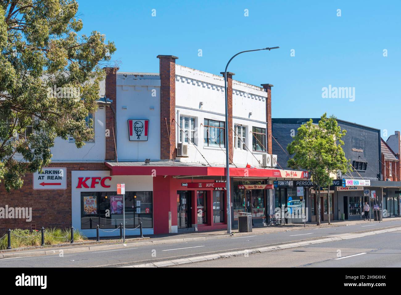 Situated in an interwar building on the Pacific Highway in Lindfield, Sydney, Australia is a KFC store alongside other small retail outlets Stock Photo