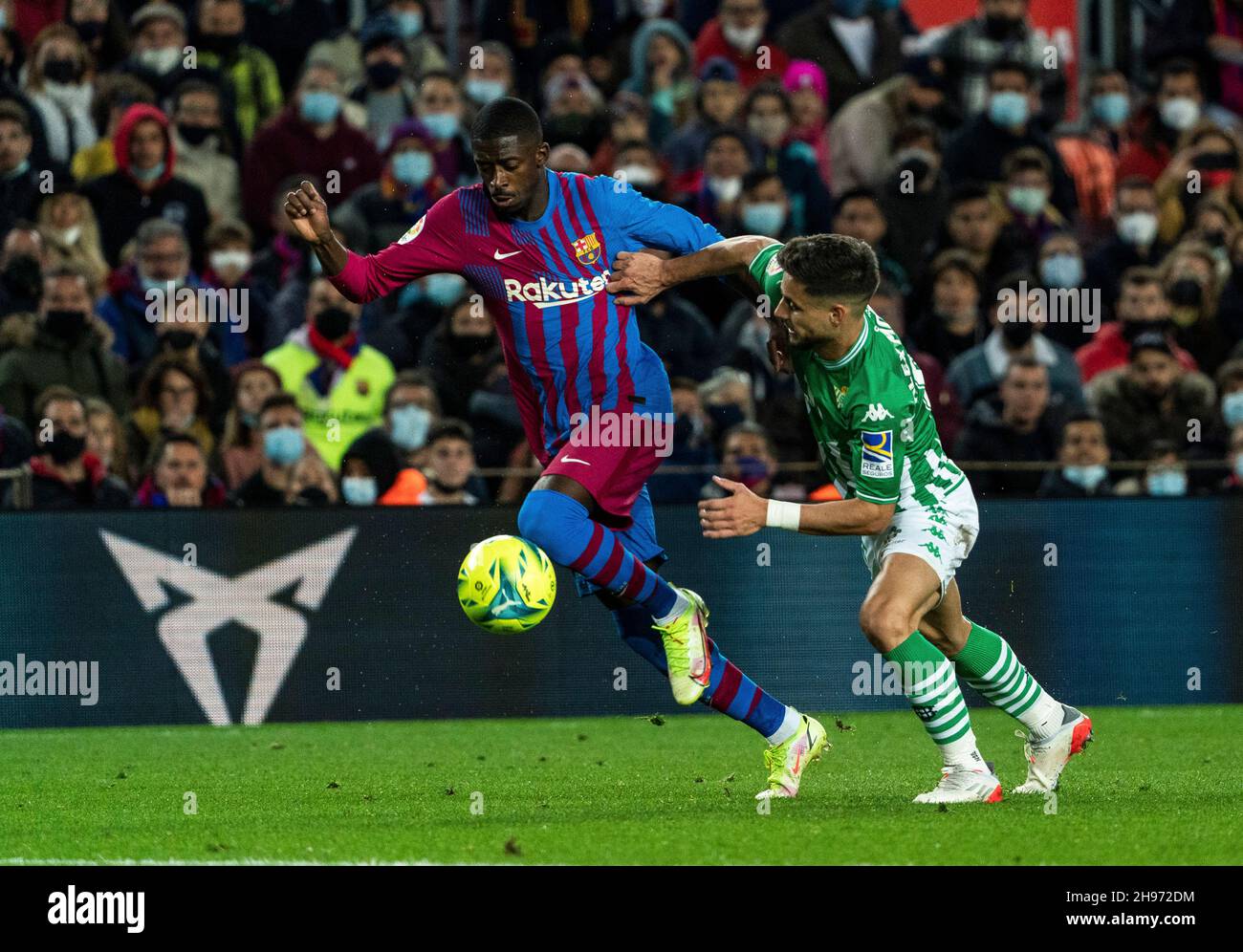 Barcelona, Spain. 4th Dec, 2021. Barcelona's Ousmane Dembele (L) vies with Real Betis' Alex Moreno during a Spanish first division league football match between FC Barcelona and Real Betis in Barcelona, Spain, Dec. 4, 2021. Credit: Joan Gosa/Xinhua/Alamy Live News Stock Photo