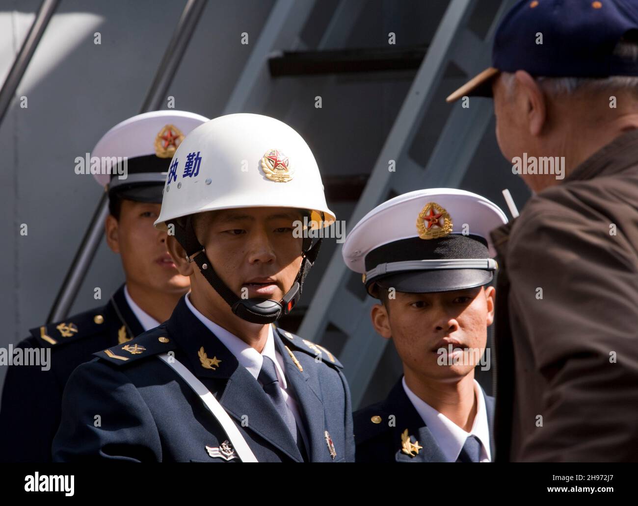 Chinese sailors welcome the public onboard The Peoples Liberation Army Navy Ship’s HAERBIN (DDG112), a LUHU Destroyer, from China visiting Auckland, New Zealand on Sunday 7 October 2007. Stock Photo