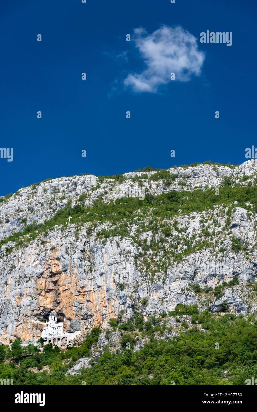High up in the cave like large rock of Ostroška Greda,into a vertical cliff face,the most popular pilgrimage place in Montenegro. Stock Photo