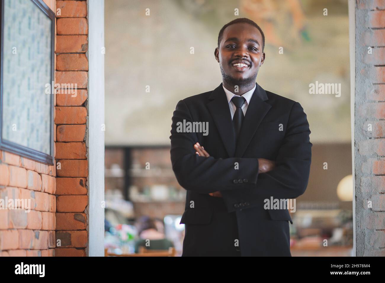 Portrait of elegant african businessman in black suit standing with ...