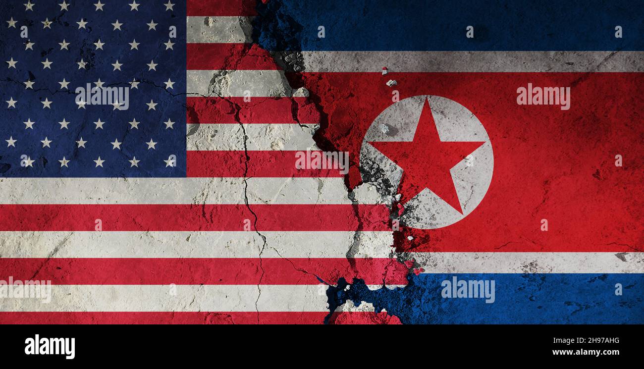 US vs North korea flag on a rough background. Broken and cracked background. Stock Photo