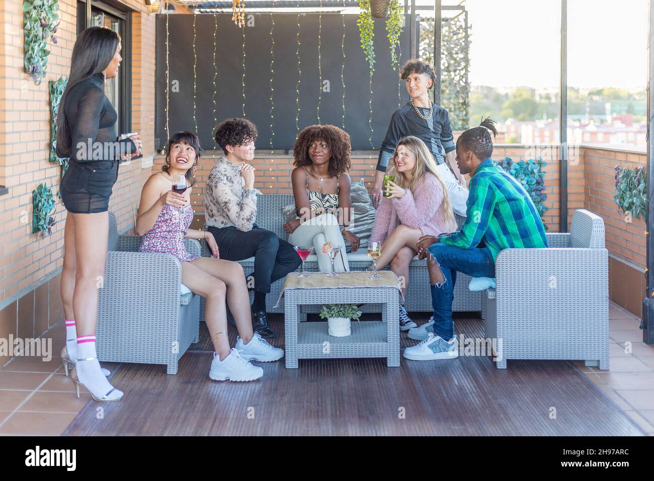Multiethnic friends on a terrace having a good time Stock Photo