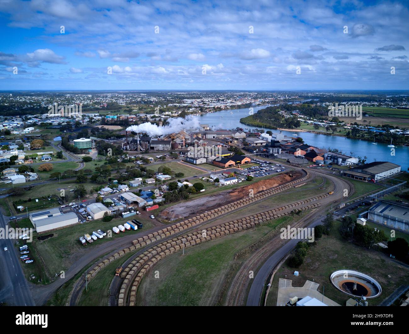 Aerial of the sugar cane trains hauling into Millaquin Sugar Mill  and distillery home of Bundaberg Rum Queensland Australia Stock Photo