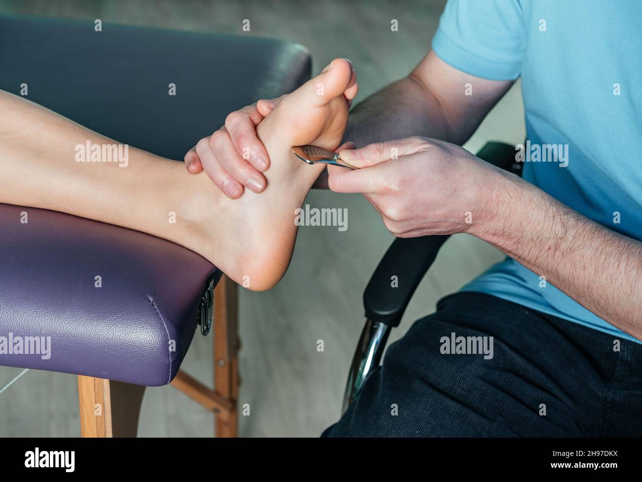 Physical therapist fixing plantar heel pain with IASTM guasha tool Stock Photo Alamy