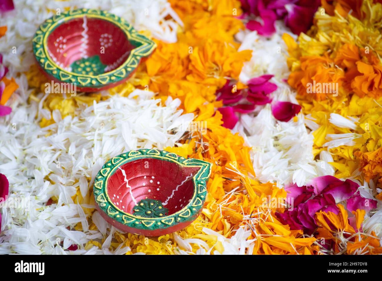 close up shot of flower petal rangoli with handmade painted earthenware