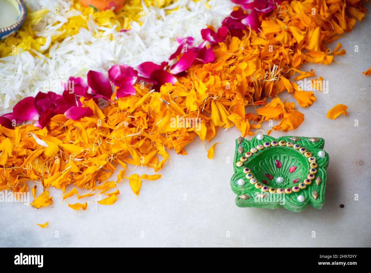 close up shot of flower petal rangoli with handmade painted earthenware