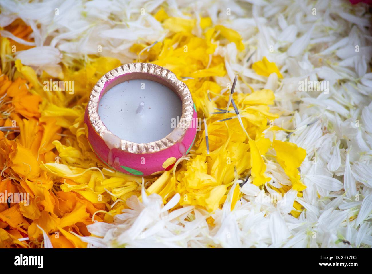 close up shot of flower petal rangoli with handmade painted earthenware