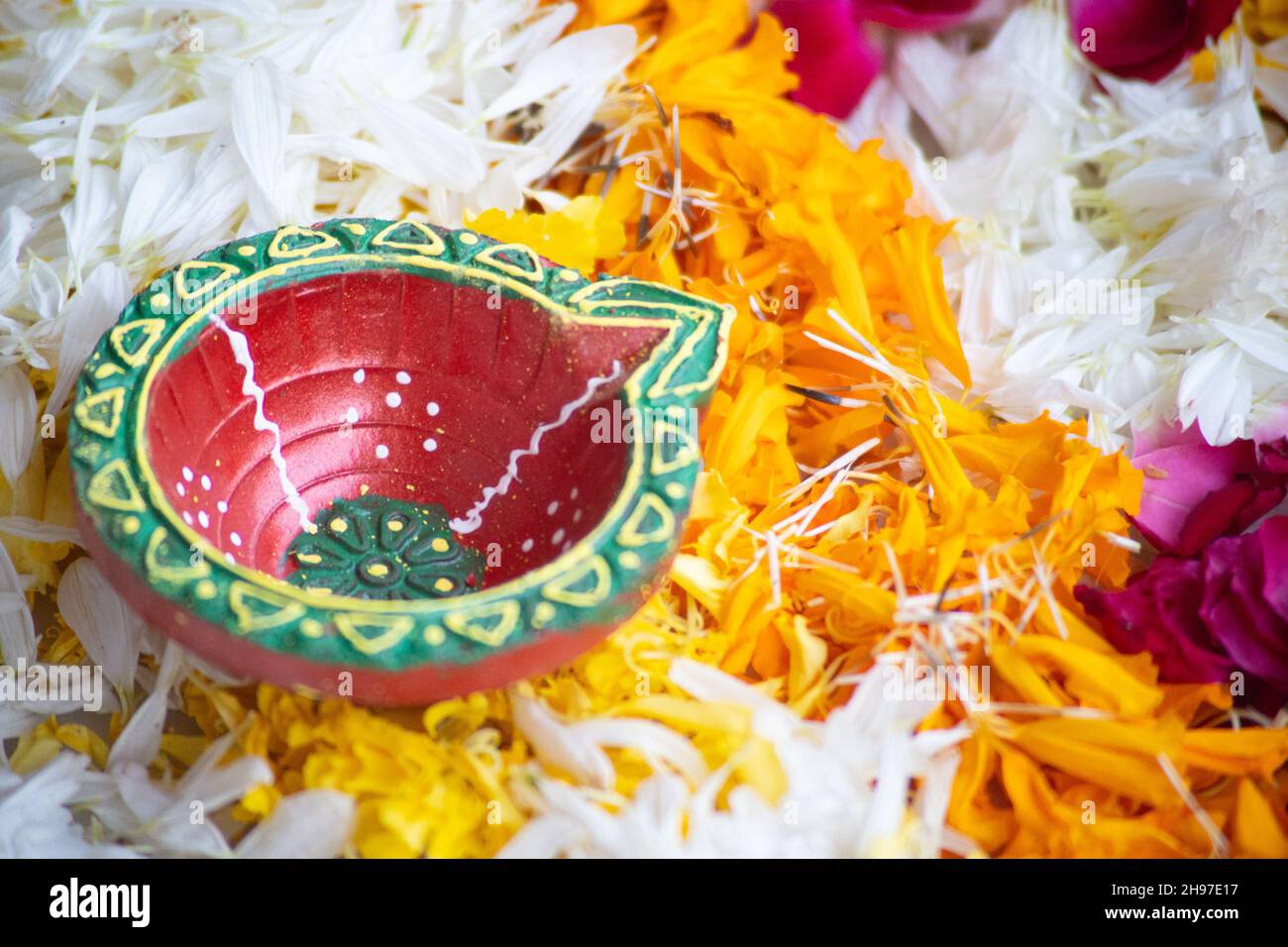 close up shot of flower petal rangoli with handmade painted earthenware