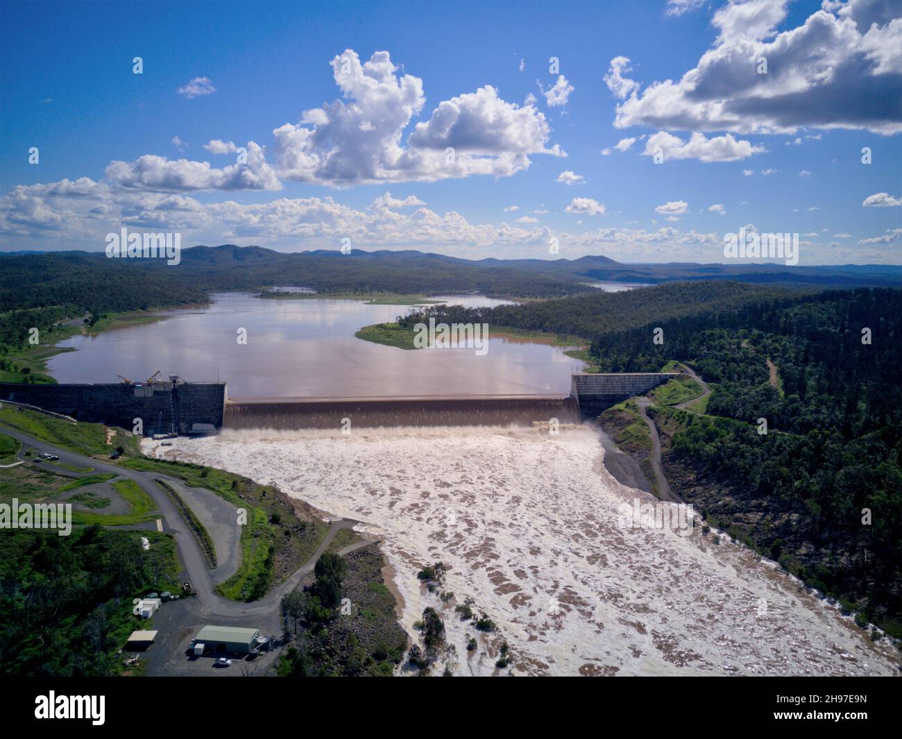 Aerial of overflowing spillway with 117% Paradise Dam on the Burnett river Queensland Australia Dec 2021 Stock Photo