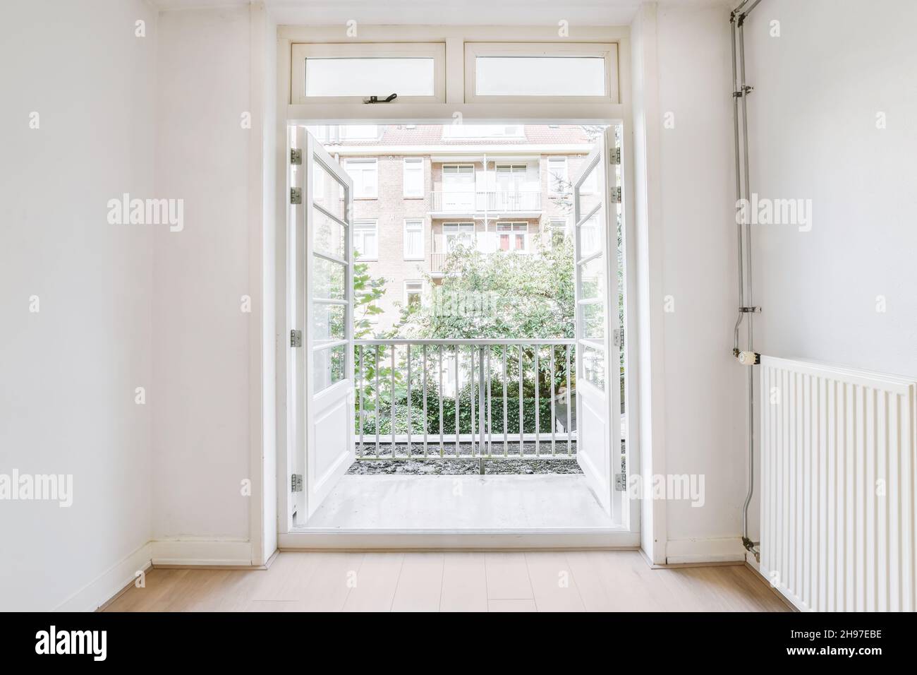 Bright room with open doors leading to the balcony Stock Photo Alamy