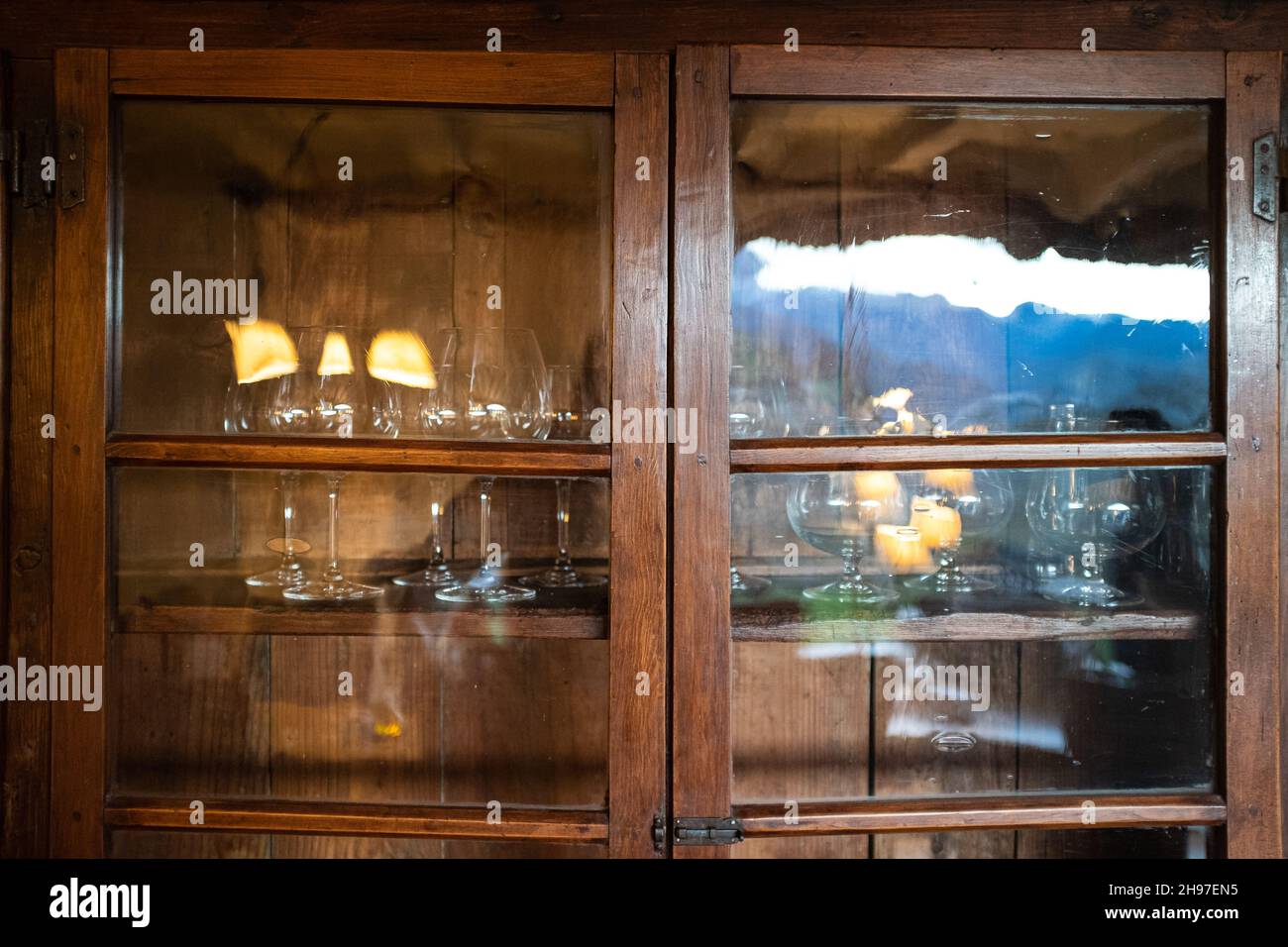 Old fashioned wooden furniture window with old wineglasses interior ...