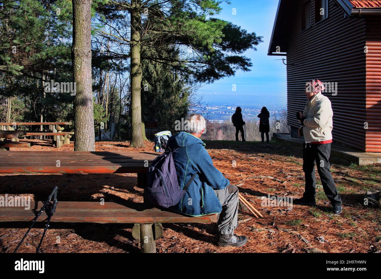Senior couple resting on a bench after hiking Stock Photo