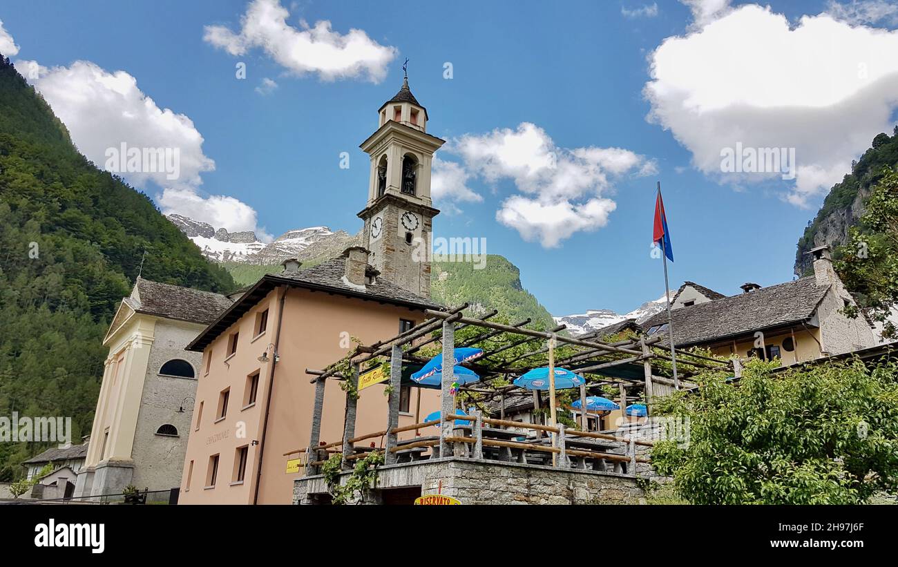 Sonogno, typical Ticino Village in Verzasca Valley, Switzerland, with church tower and restaurant terrace. Stock Photo