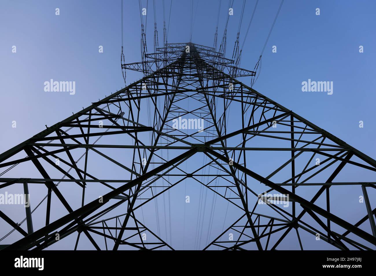Large Electricity pylon (Strommasten) also overhead line pylon in Winter. Up View. Stock Photo