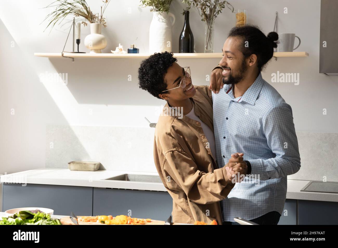 Happy African American couple dancing in kitchen Stock Photo - Alamy