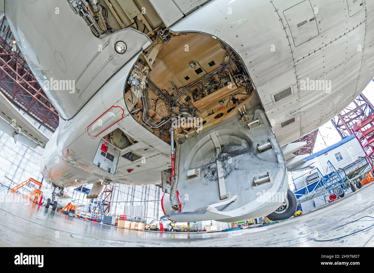 Aviation hangar with airplane, closeup landing gear of the airplane