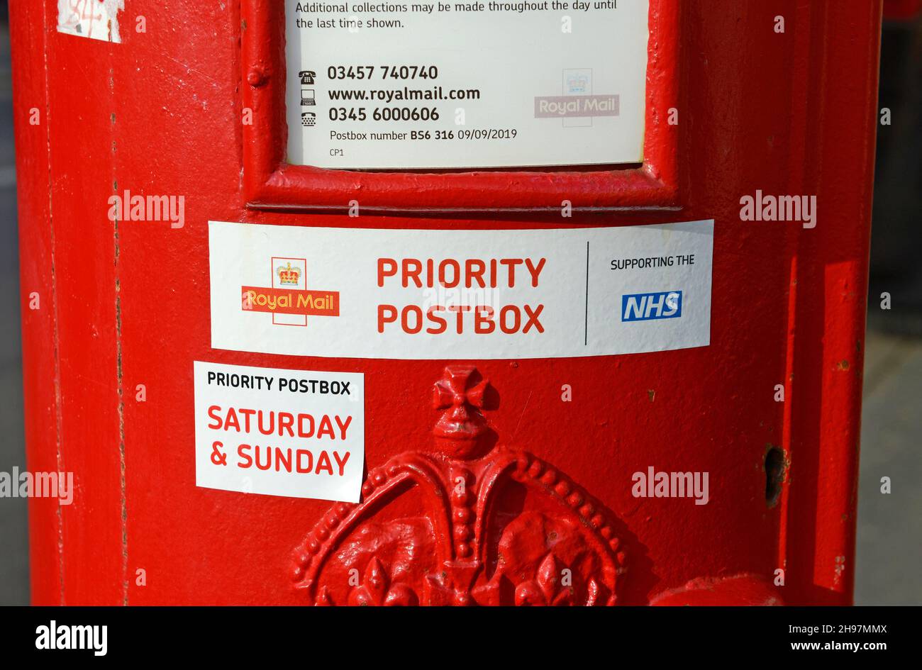 Royal Mail postbox with priority postbox NHS sticker in Bristol, UK Stock Photo
