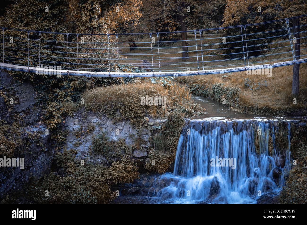 Scenic view of the wooden bridge over a small waterfall. Tbilisi Botanical Garden. Georgia. Stock Photo