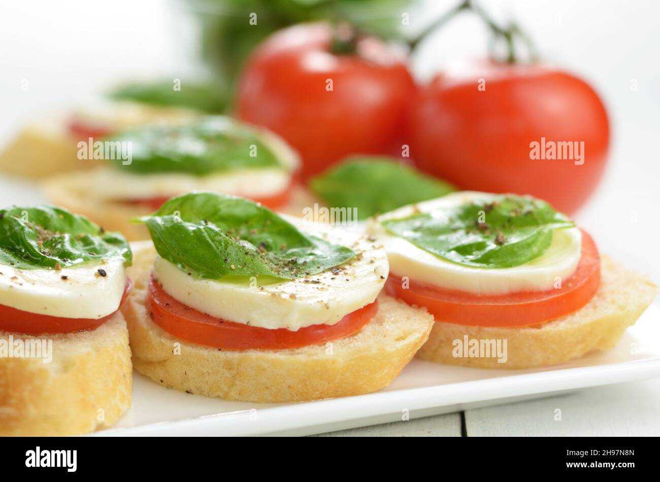 Caprese bruschettas of toast mozzarella tomato and basil Stock Photo