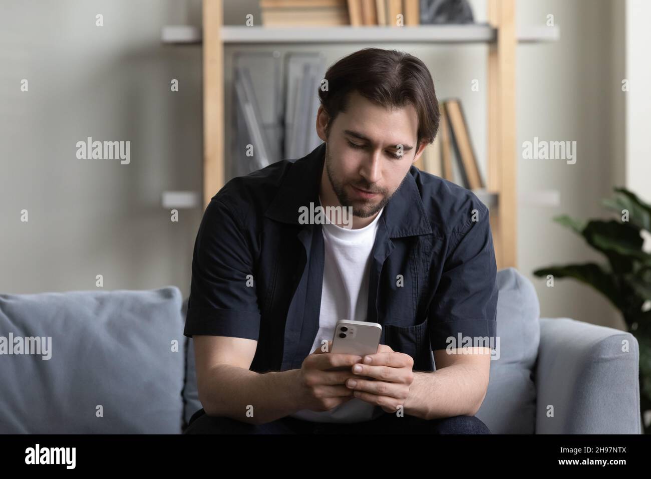 Focused cell user reading text message on mobile phone screen Stock Photo