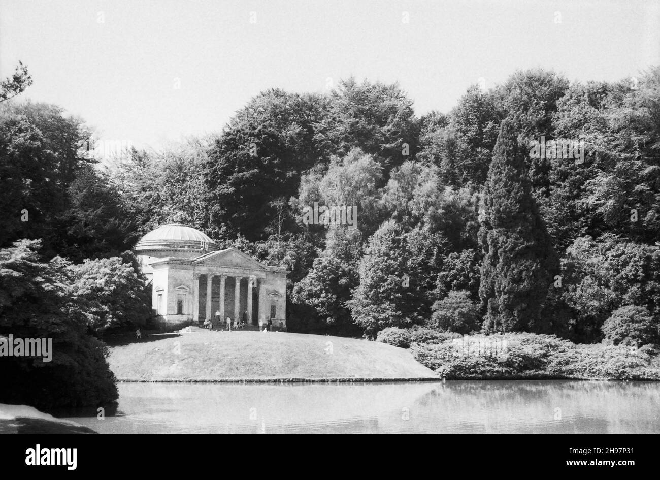 High Summer at Stourhead Garden, Stourton, Wiltshire, UK, showing the Pantheon, designed by Henry Flitcroft and built in 1753, on the opposite bank of the lake. Black and white archive film photograph from 1990 Stock Photo