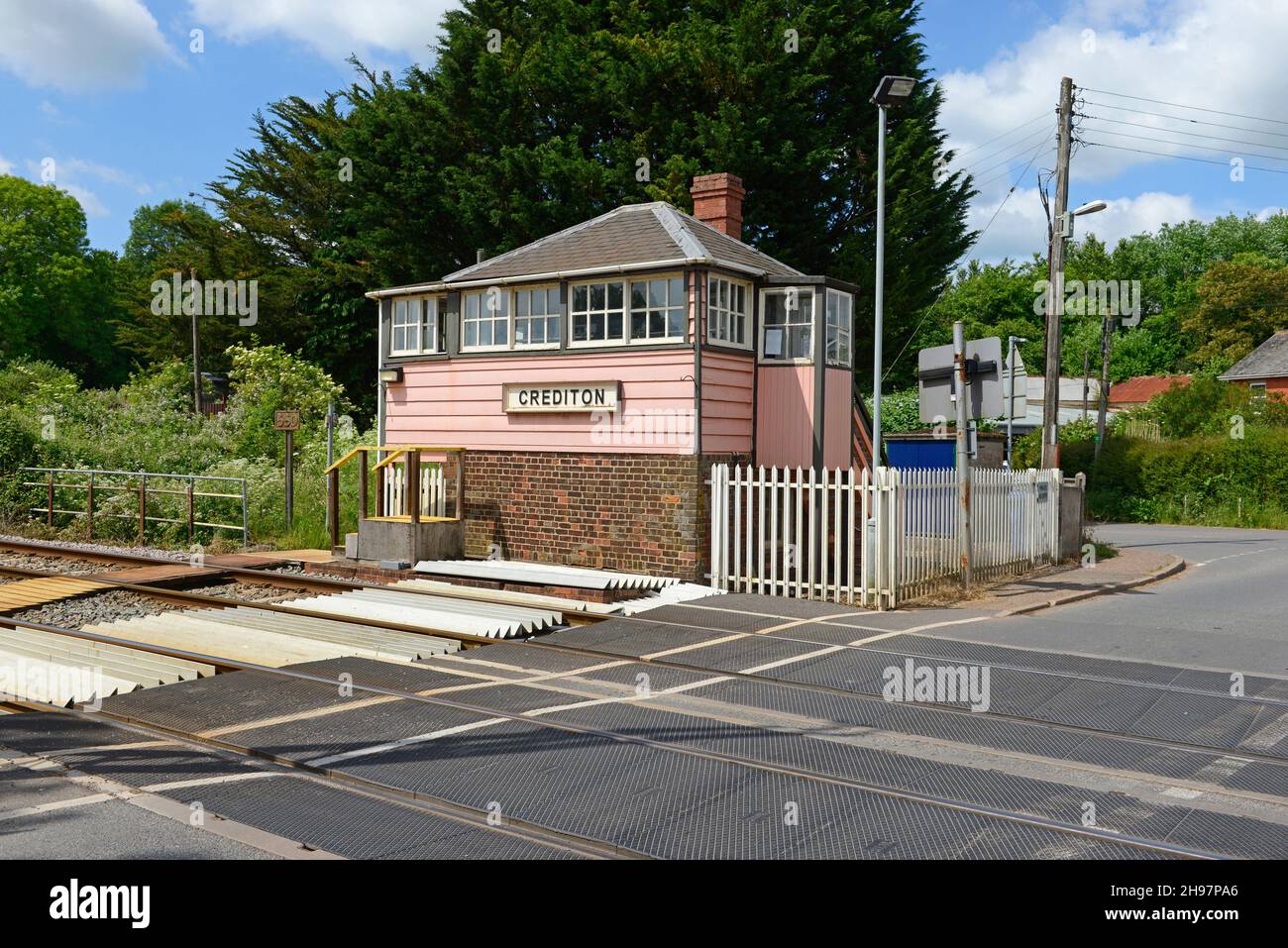 The signalbox at Crediton in Devon was built during the Victorian era and is still in use today. The pink colour is that of the old LSWR rail company. Stock Photo