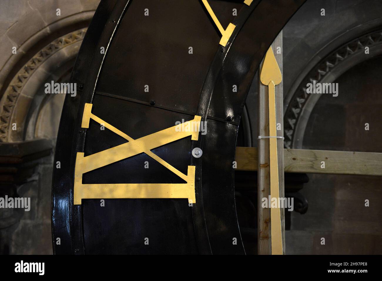 The restored dial of the revamped Canterbury Cathedral clock is on display inside the building prior to its return to one of the towers. Stock Photo